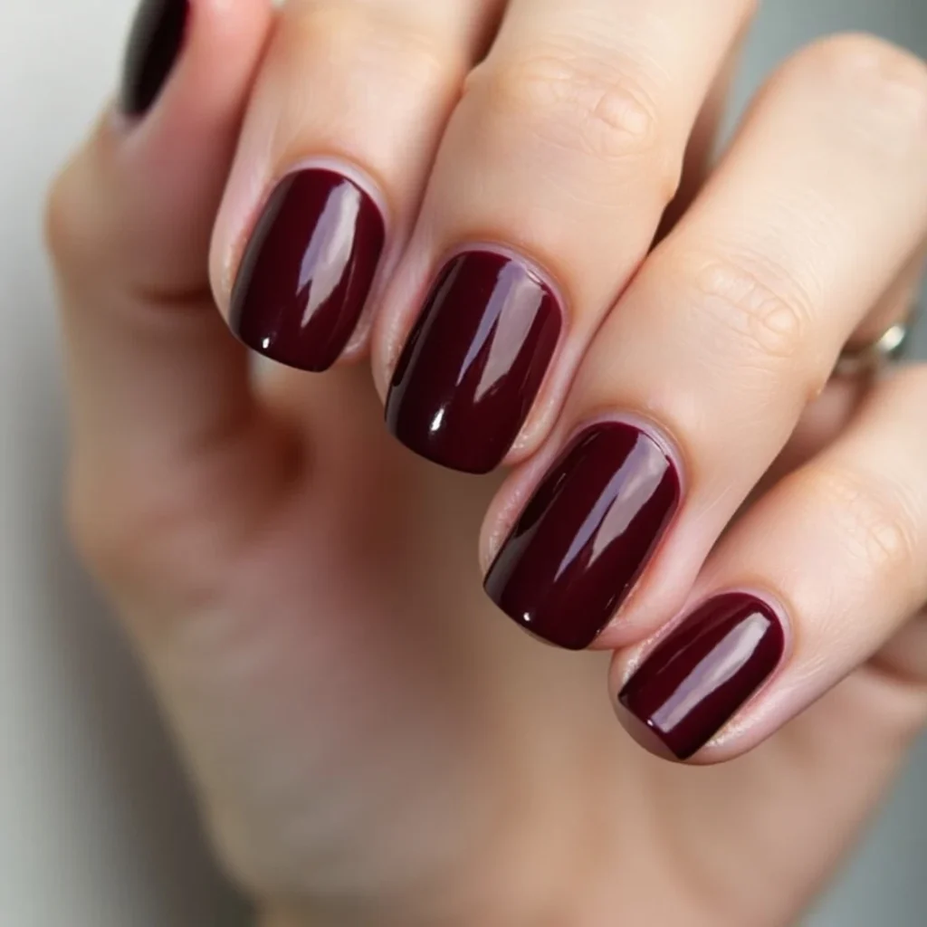 Glossy deep burgundy fall nails in almond shape